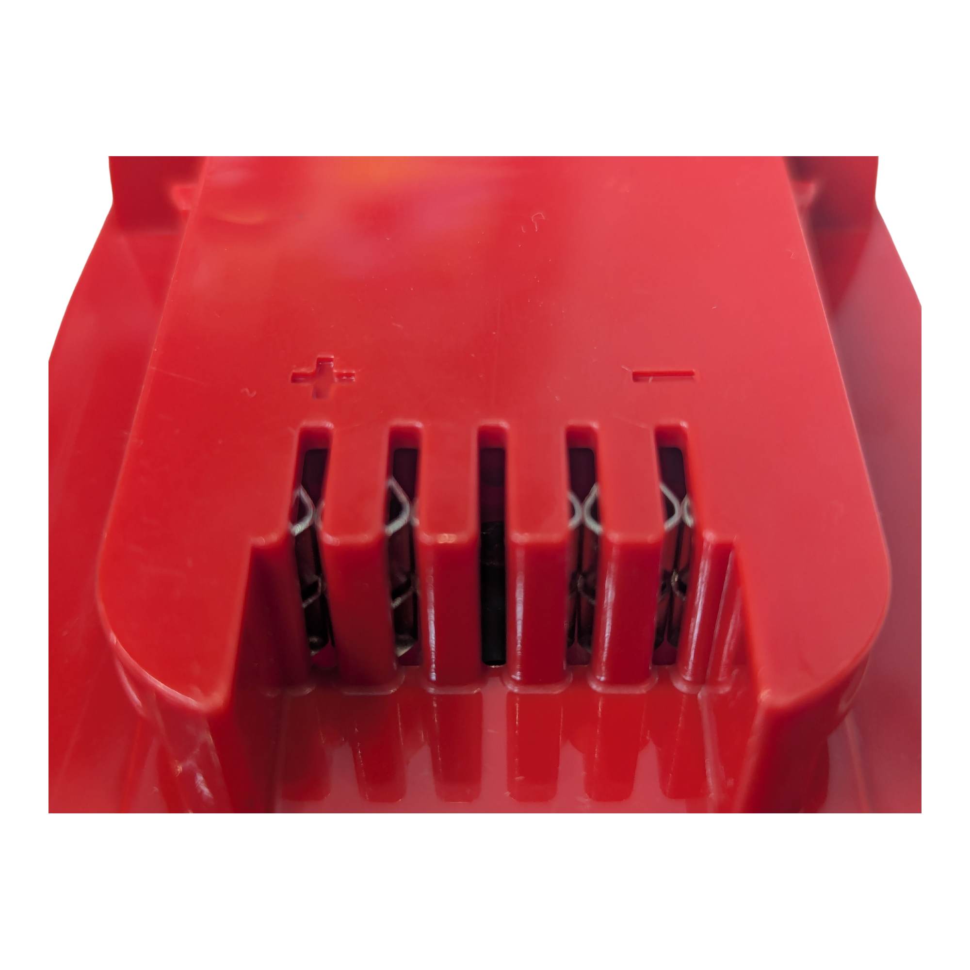 Black and Decker 20V to Milwaukee M18 battery adapter - close-up of the tool-side slots, + and - marks and copper contacts